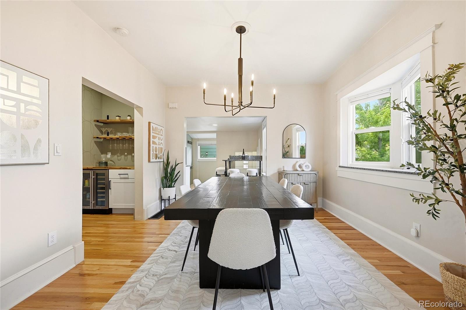 4546 Meade Street Denver, CO 80211 - Photo 9 of 35 a dining room with chandelier and wooden floor
