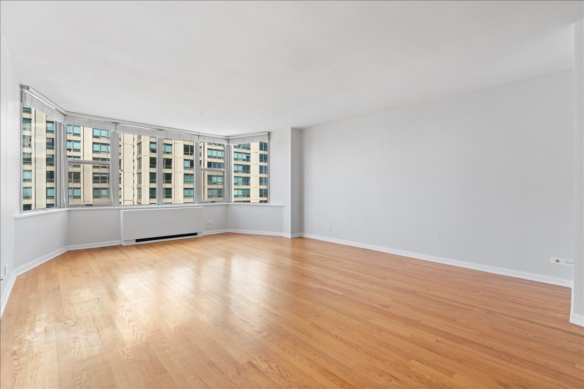 525 West Hawthorne Place, Unit 808 Chicago, IL 60657 - Photo 11 of 29 wooden floor in an empty room with a window