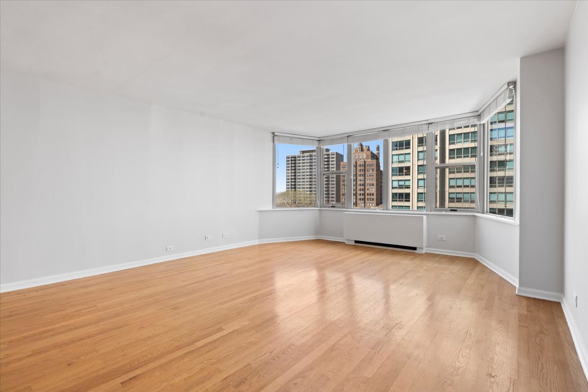 525 West Hawthorne Place, Unit 808 Chicago, IL 60657 - Photo 12 of 29 wooden floor in an empty room with a window