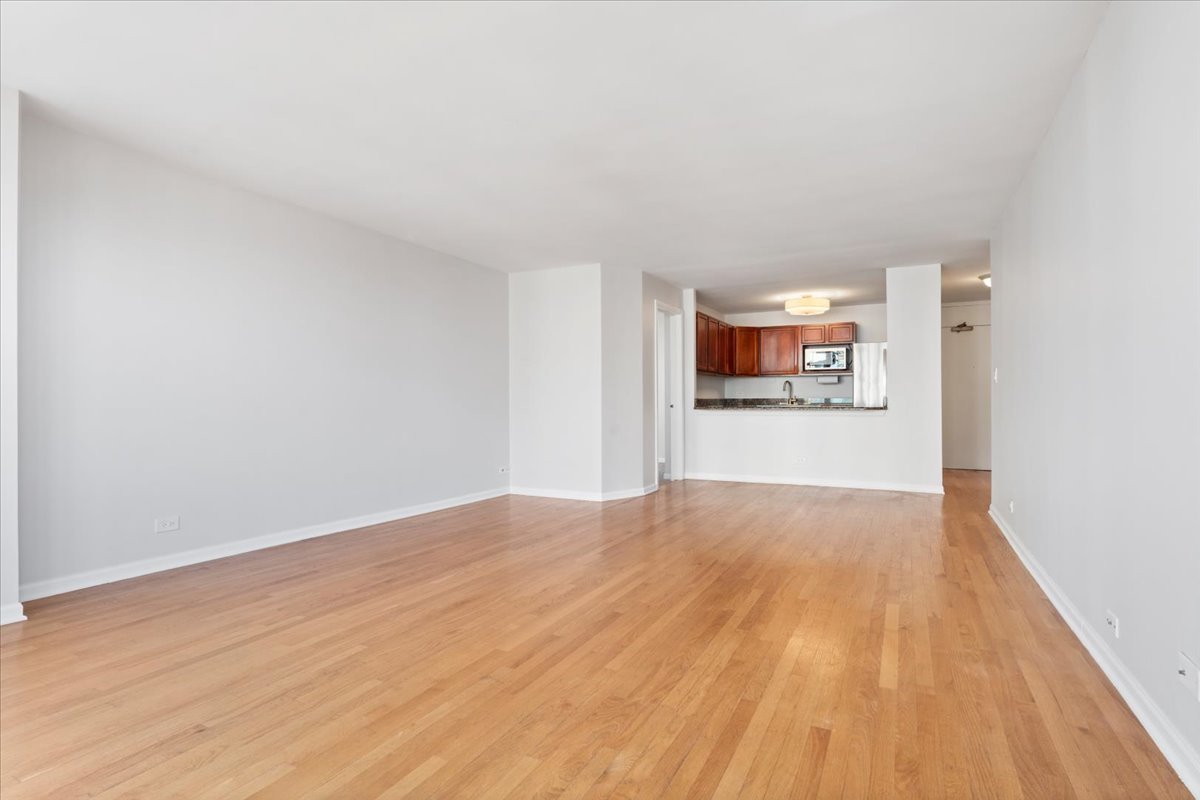 525 West Hawthorne Place, Unit 808 Chicago, IL 60657 - Photo 14 of 29 a view of empty room with wooden floor