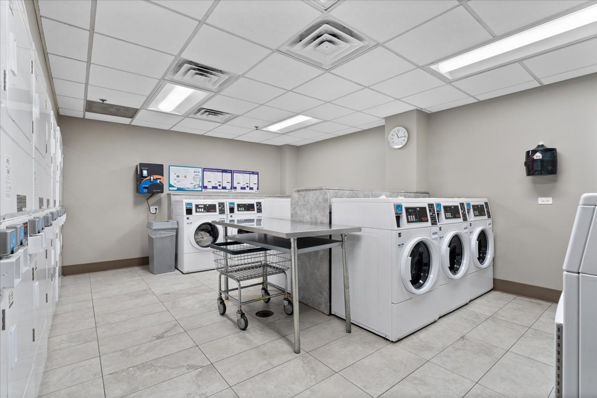 525 West Hawthorne Place, Unit 808 Chicago, IL 60657 - Photo 29 of 29 a utility room with dryer washer and a view of living room