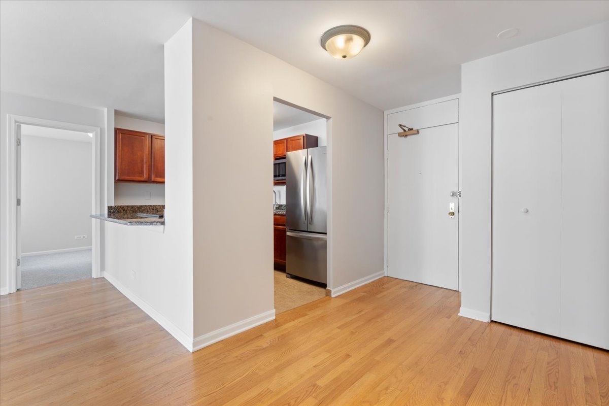 525 West Hawthorne Place, Unit 808 Chicago, IL 60657 - Photo 6 of 29 a view of a livingroom with wooden floor and a refrigerator