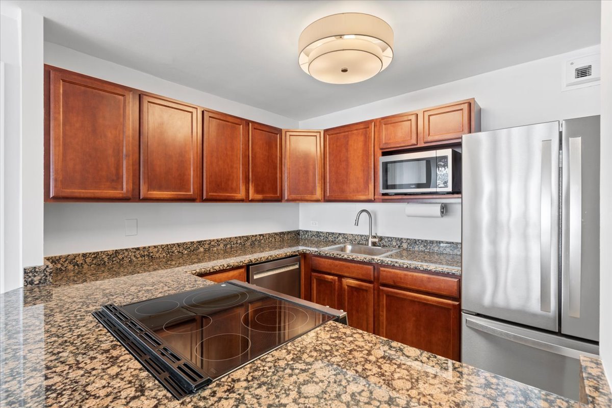 525 West Hawthorne Place, Unit 808 Chicago, IL 60657 - Photo 8 of 29 a kitchen that has a sink and a stove in it