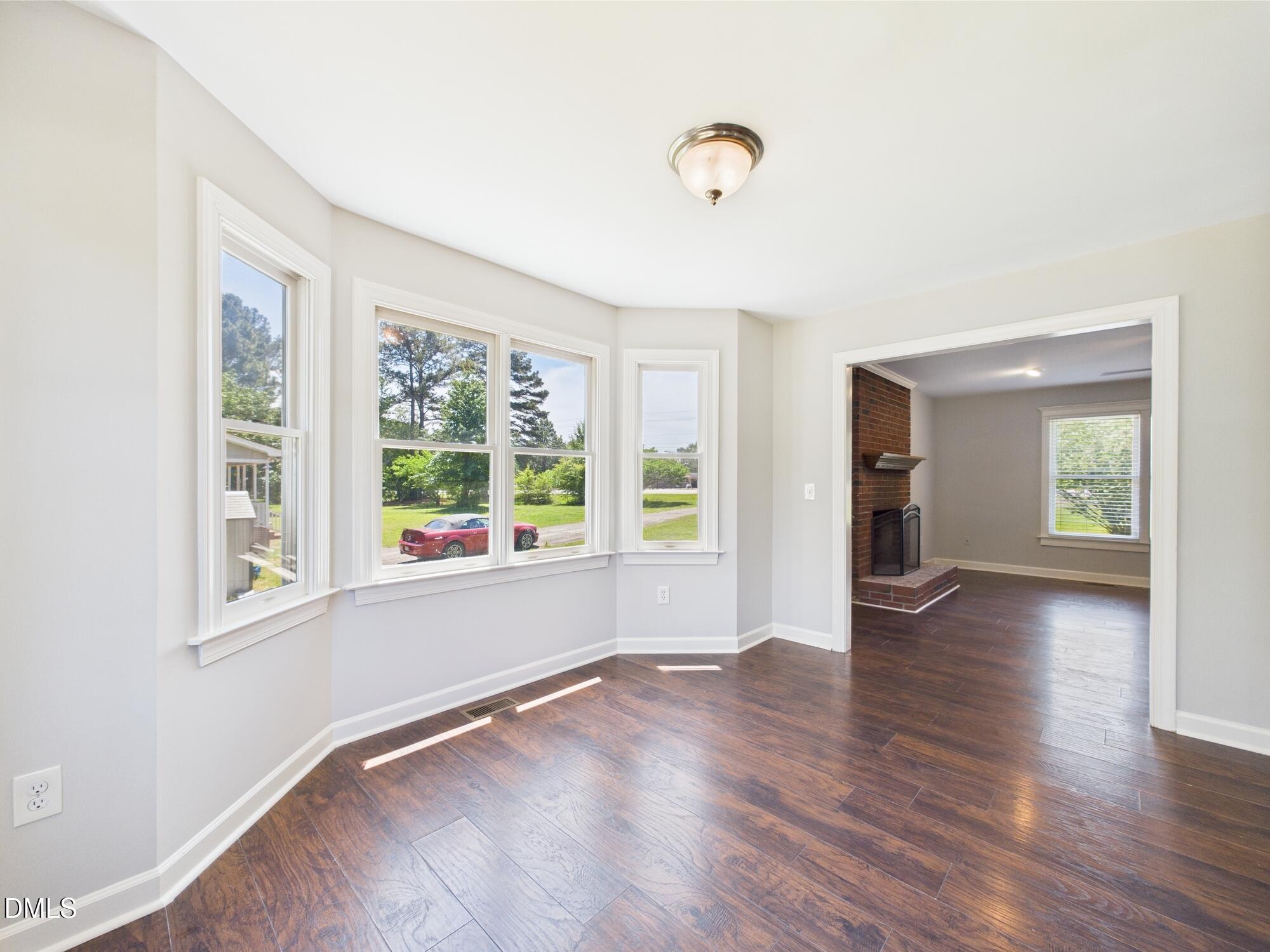 10917 Fanny Brown Road Raleigh, NC 27603 - Photo 20 of 54 an empty room with wooden floor and windows