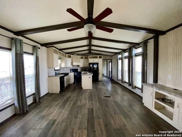 a view of open kitchen with a sink wooden floor and a window