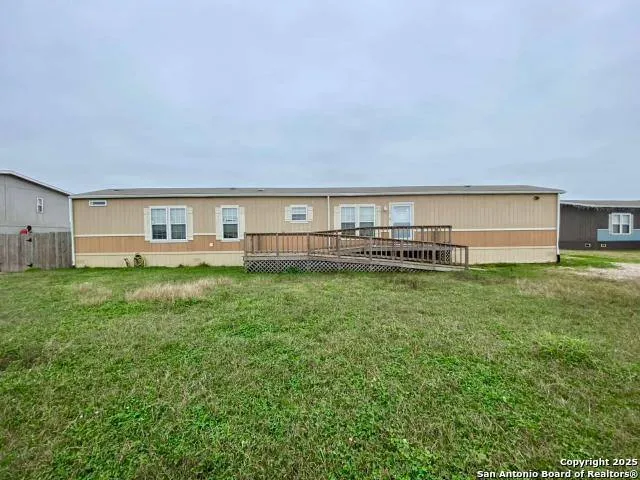 a view of house with backyard