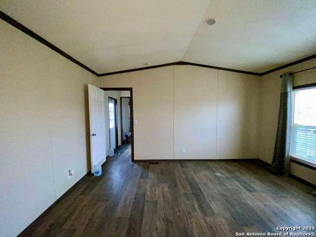 13009 Annette Road Angleton, TX 77515 - Photo 7 of 14 an empty room with wooden floor and windows