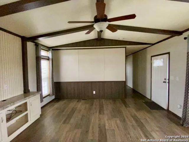 a view of room with window and wooden floor