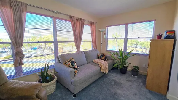 a living room with furniture and a potted plant