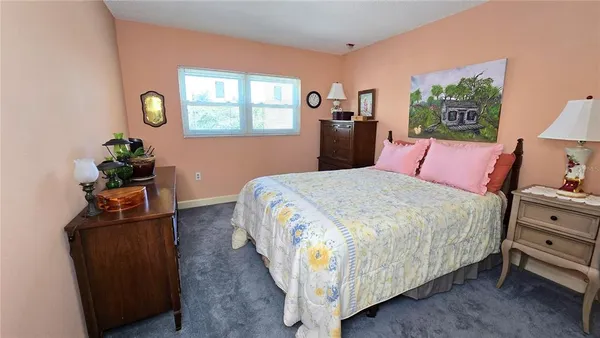 a bedroom with bed and window