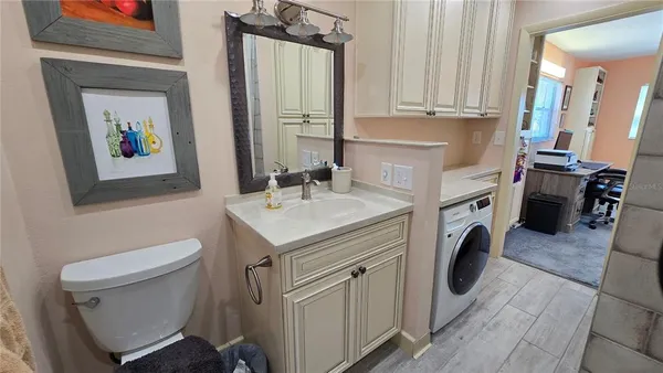 a bathroom with a sink a washer and dryer
