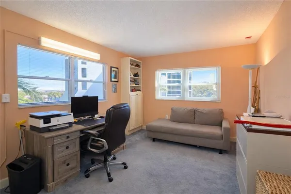 a livingroom with workspace and a window