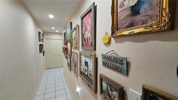 a view of a hallway with paintings on the wall