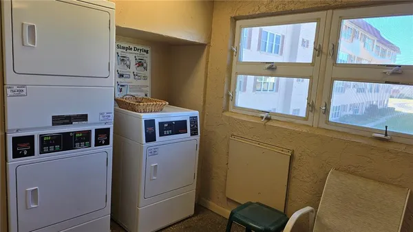 a room with a chair a flat screen tv and a bed