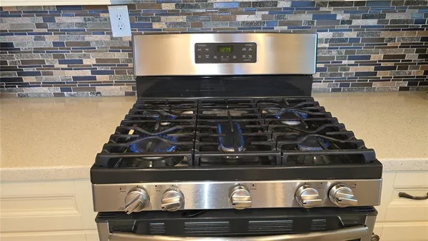 a stove sitting inside of a kitchen
