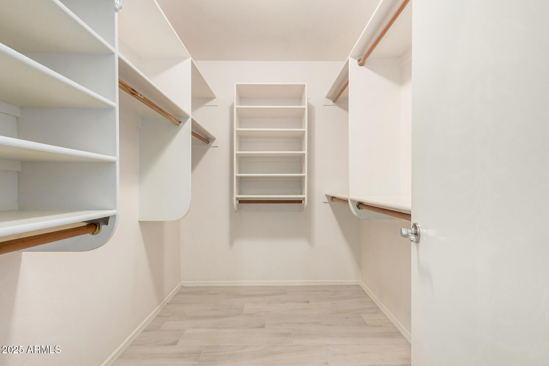 4632 East Mossman Road Phoenix, AZ 85050 - Photo 14 of 24 a view of walk in closet with empty racks