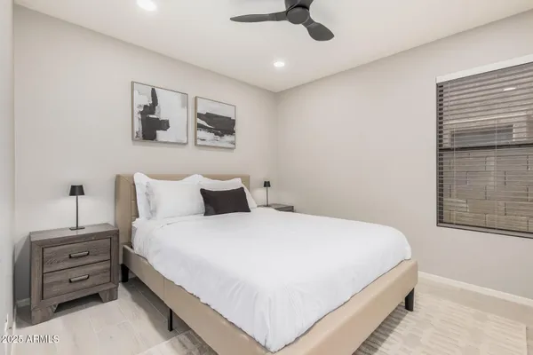 a bedroom with a bed lamp and a window