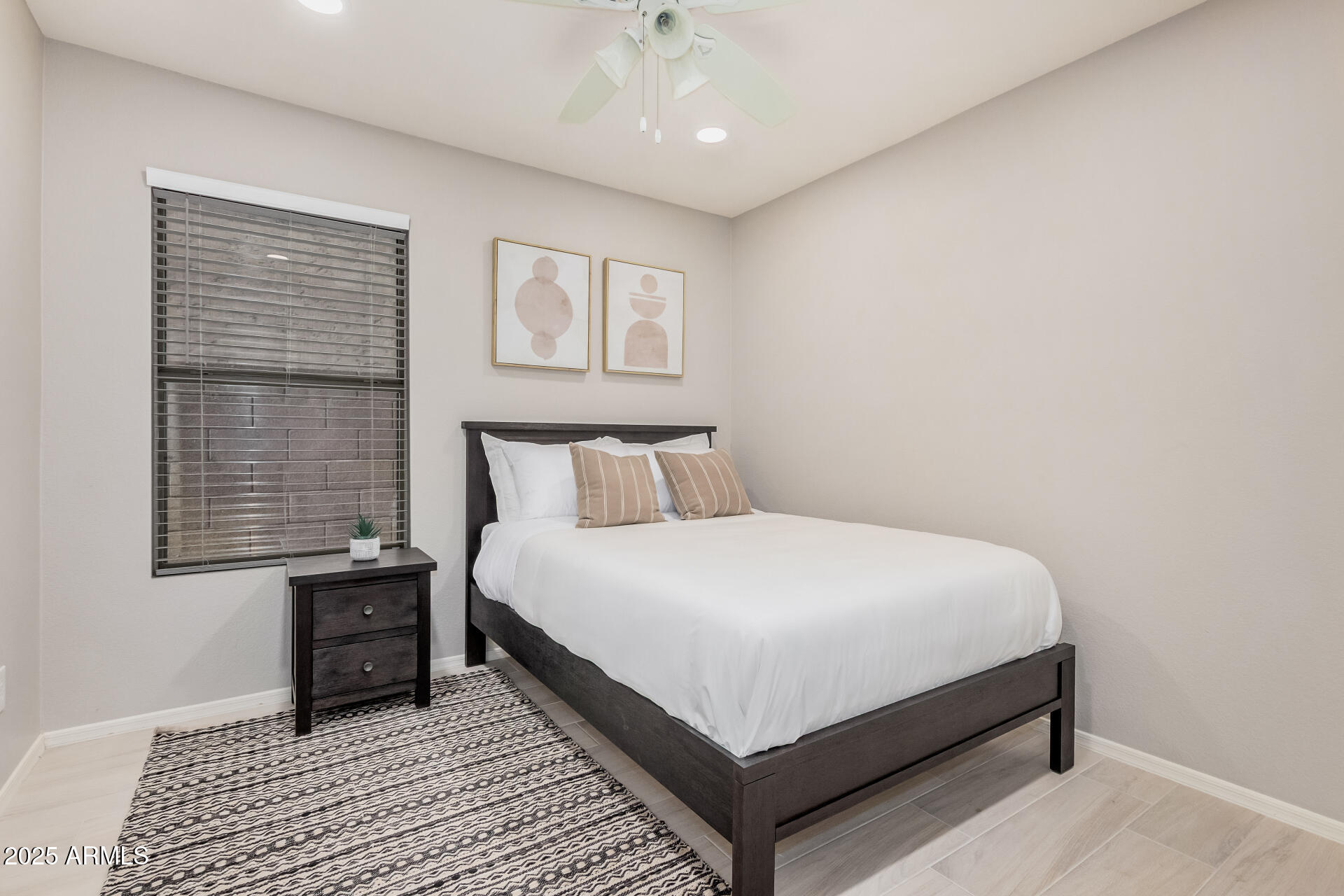 4632 East Mossman Road Phoenix, AZ 85050 - Photo 18 of 24 a bedroom with a bed lamp and a window