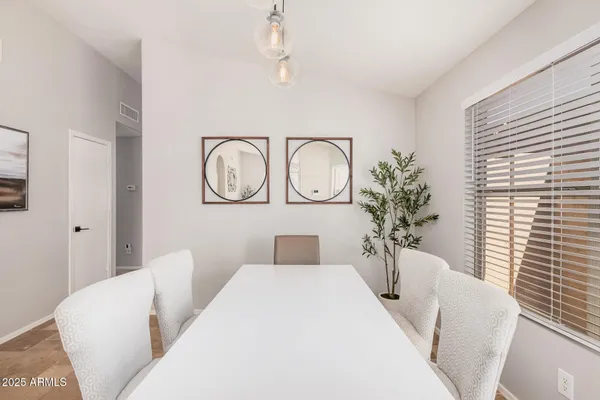 a living room with furniture a window and a potted plant