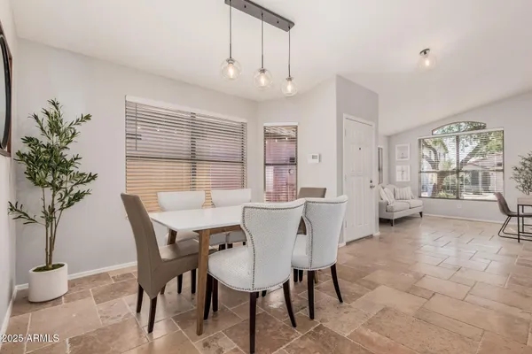 a view of a dining room with furniture and window