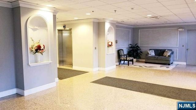 290 Anderson Street, Unit 6I Hackensack, NJ 07601 - Photo 4 of 12 a living room with furniture and a flat screen tv