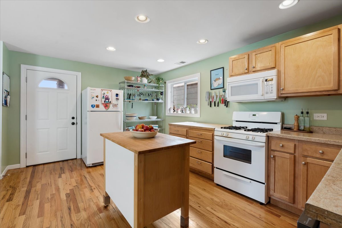 2735 North Ridgeway Avenue Chicago, IL 60647 - Photo 6 of 40 a kitchen with stainless steel appliances granite countertop a stove and a sink