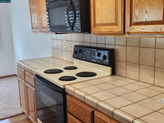 a kitchen with a stove a sink and a microwave