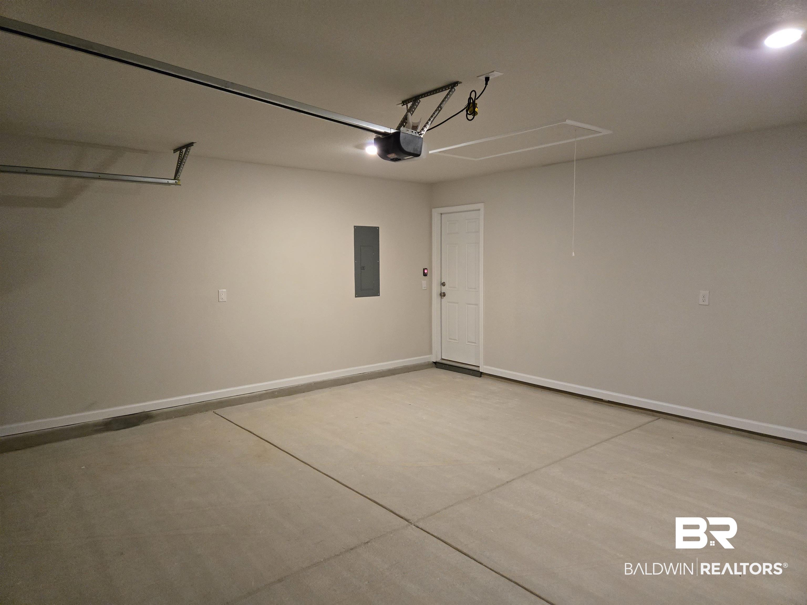 24194 Veranda Circle Elberta, AL 36530 - Photo 14 of 31 Garage featuring electric panel and a garage door opener