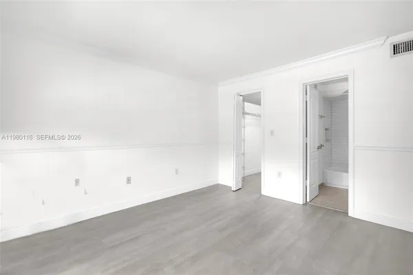 an empty room with wooden floor