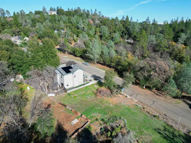 an aerial view of a house with a yard