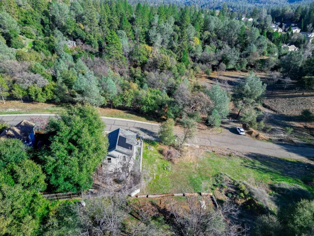 an aerial view of a house with a yard