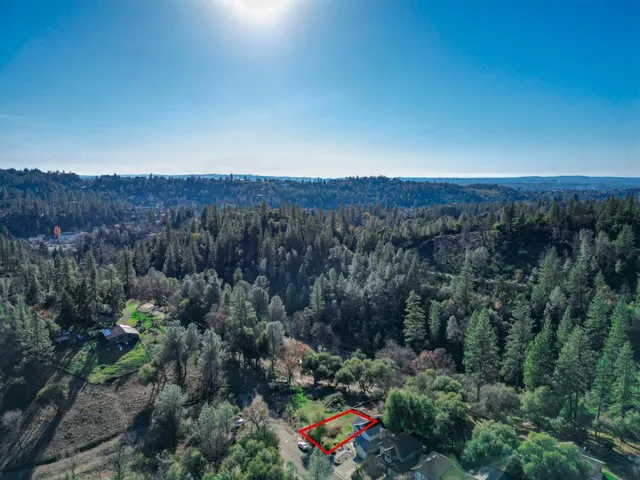 an aerial view of a houses with a yard