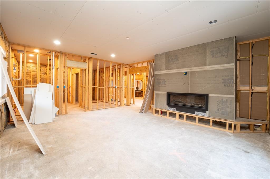 337 Chestnut Ridge Road Latrobe, PA 15650 - Photo 16 of 25 an empty room with a fireplace and sliding door