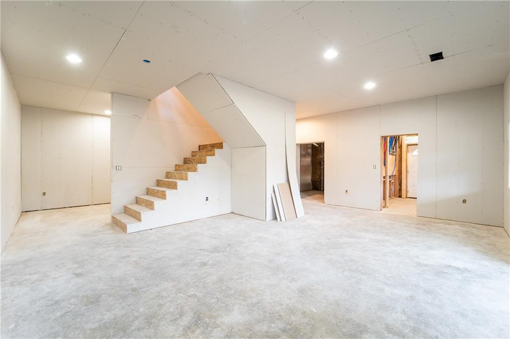 337 Chestnut Ridge Road Latrobe, PA 15650 - Photo 21 of 25 an empty room with stairs and white walls