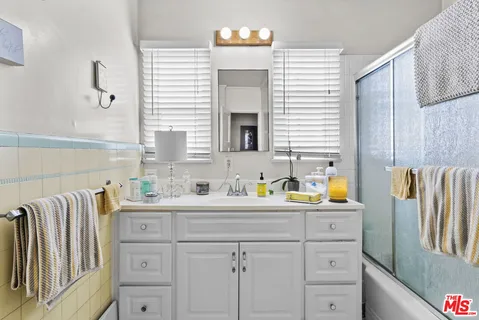 a kitchen with a sink cabinets and wooden floor