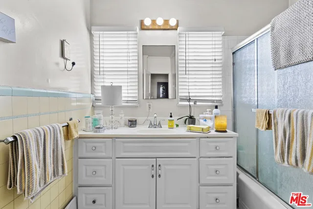 a kitchen with a sink cabinets and wooden floor