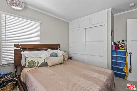 a bedroom with a bed and a closet