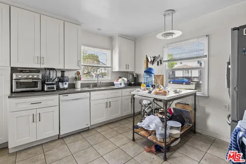 a kitchen with a sink cabinets and window