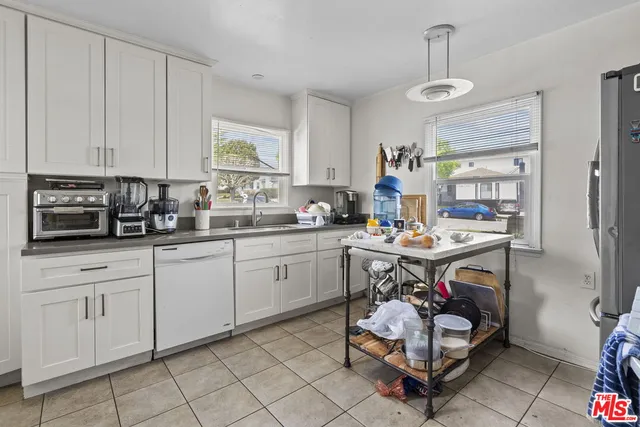 a kitchen with a sink cabinets and window