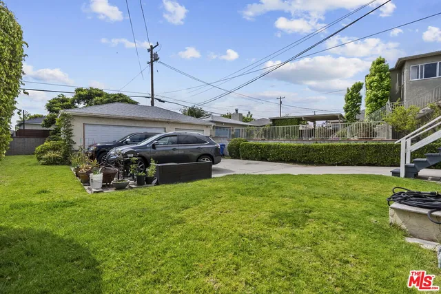 a view of a backyard with sitting area