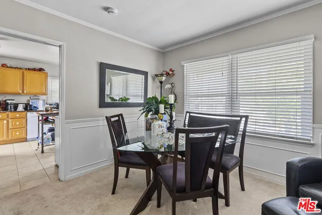 a view of a dining room with furniture and window