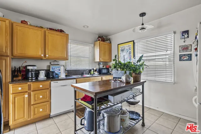 a kitchen with a stove a sink and a refrigerator