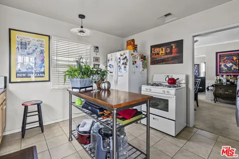 a living room with furniture a flat screen tv and a table