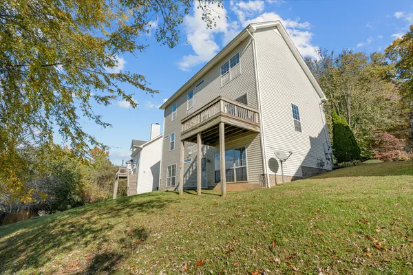 a kitchen with stainless steel appliances granite countertop a stove a sink a microwave a refrigerator a stove and white cabinets