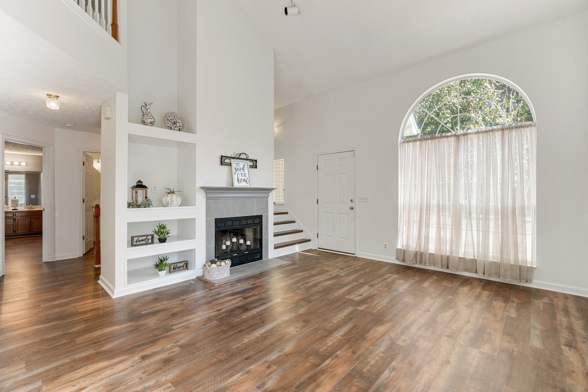 1068 Tulip Grove Road Hermitage, TN 37076 - Photo 27 of 100 an empty room with windows a fireplace and wooden floor