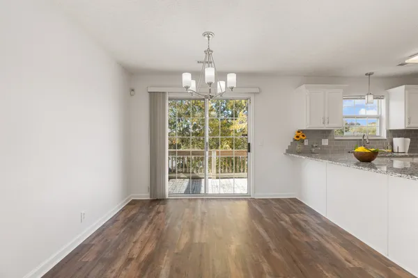 a bathroom with a sink a toilet a mirror and shower