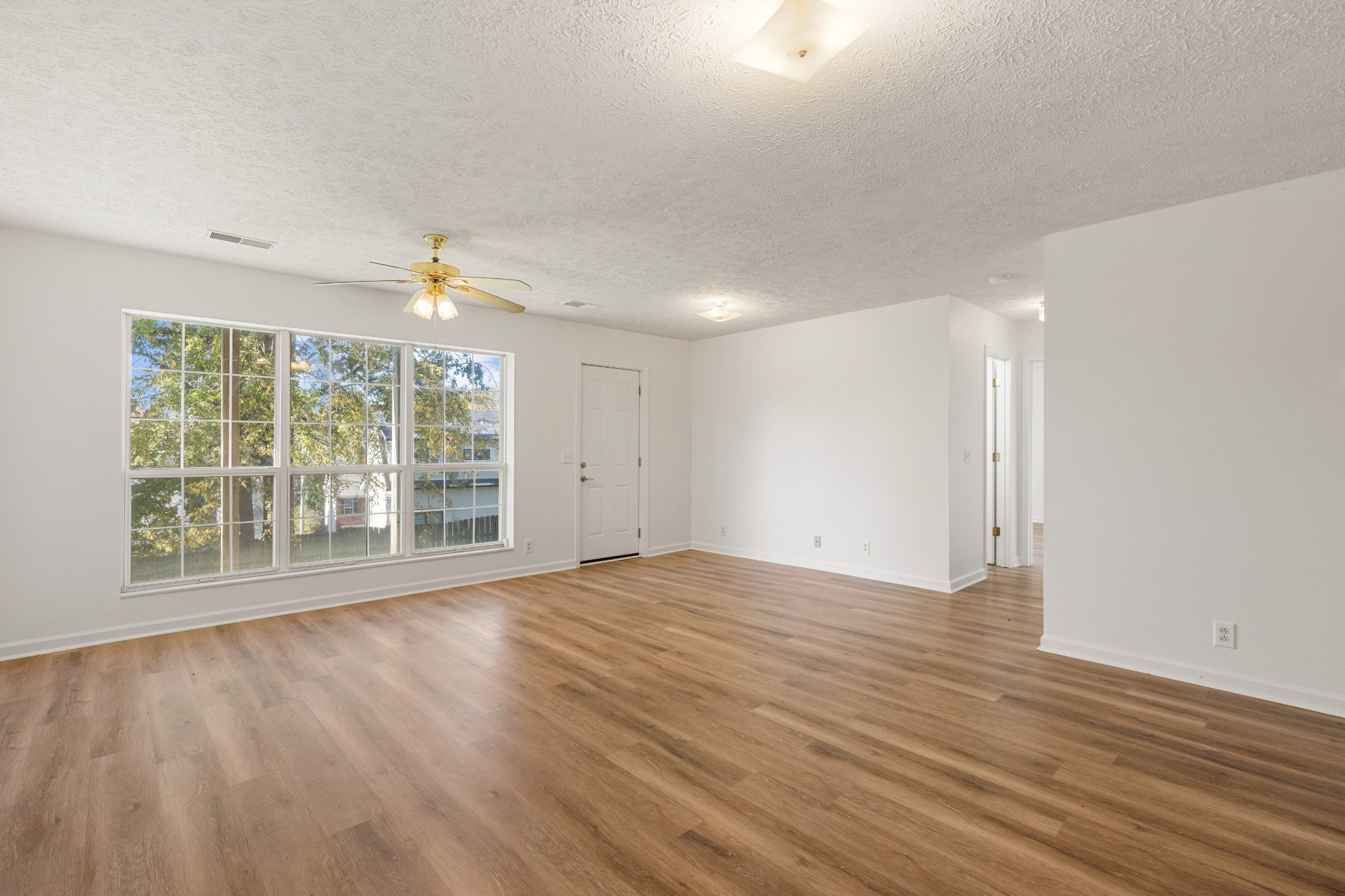 1068 Tulip Grove Road Hermitage, TN 37076 - Photo 80 of 100 a view of an empty room with wooden floor and a window