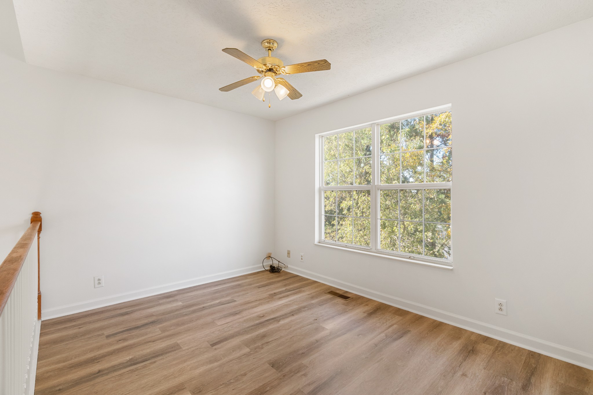 1068 Tulip Grove Road Hermitage, TN 37076 - Photo 83 of 100 a view of an empty room with wooden floor and a window