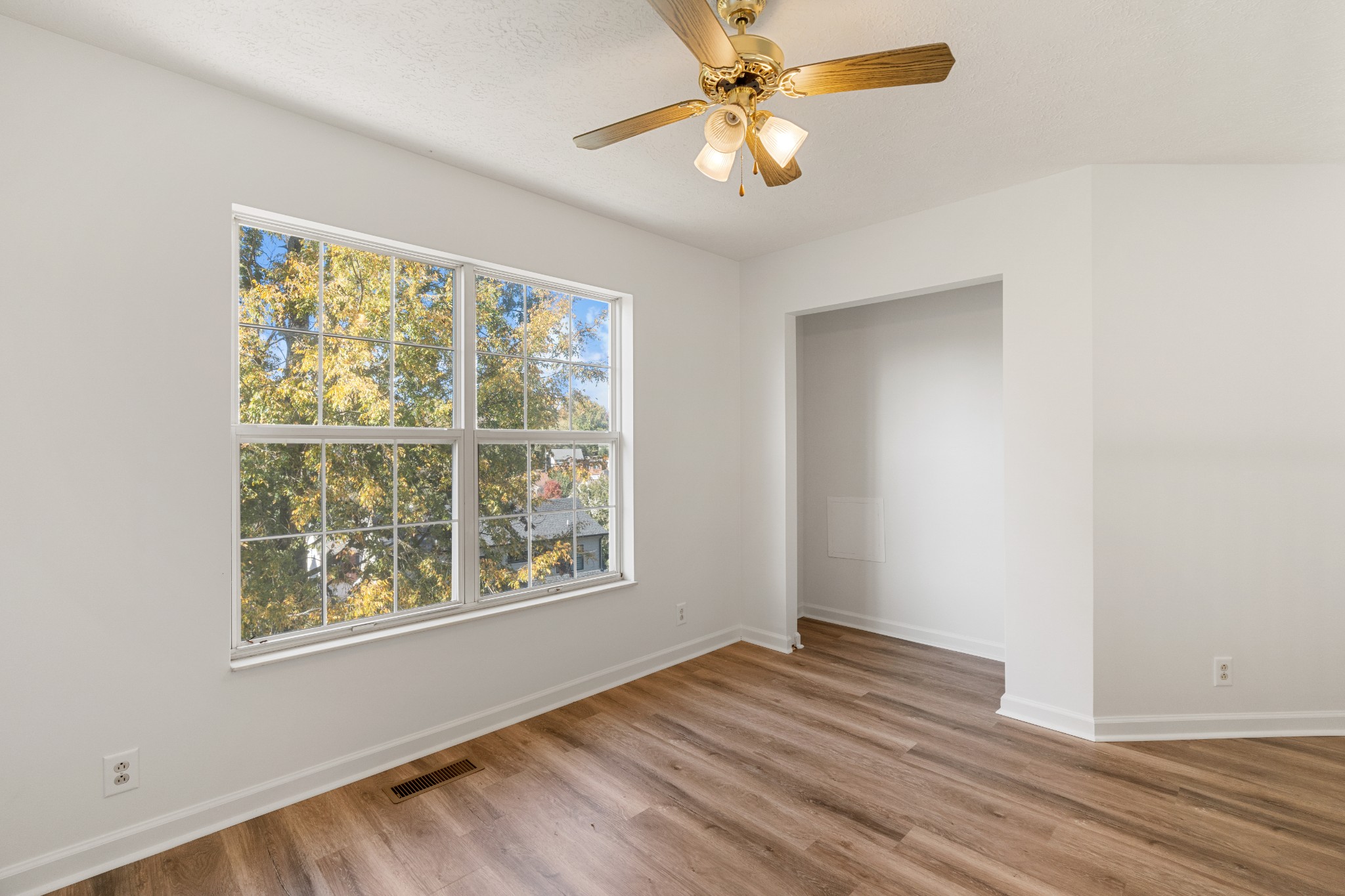 1068 Tulip Grove Road Hermitage, TN 37076 - Photo 84 of 100 a view of an empty room with wooden floor and a window