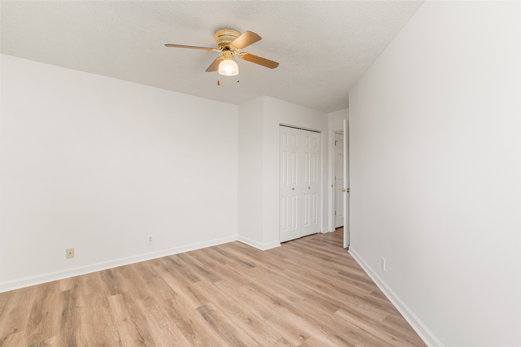 1068 Tulip Grove Road Hermitage, TN 37076 - Photo 87 of 100 a view of a room with wooden floor and a ceiling fan